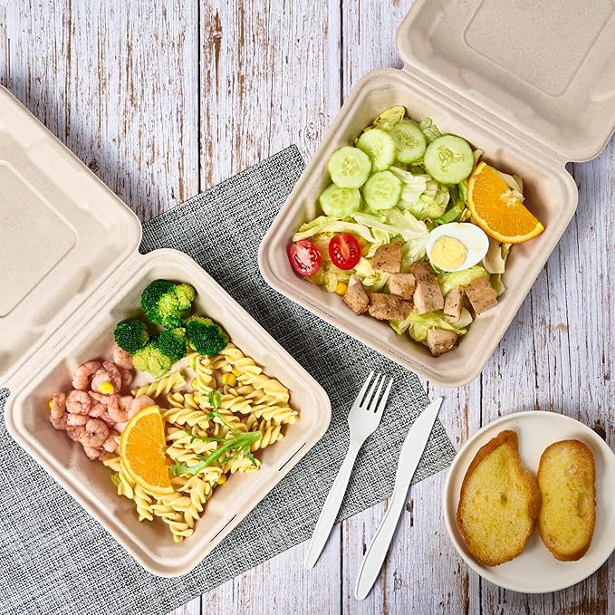Two ECOLipak eco-friendly takeout containers with pasta, shrimp, and broccoli, plus a fresh salad, orange slice, and two pieces of garlic bread.
