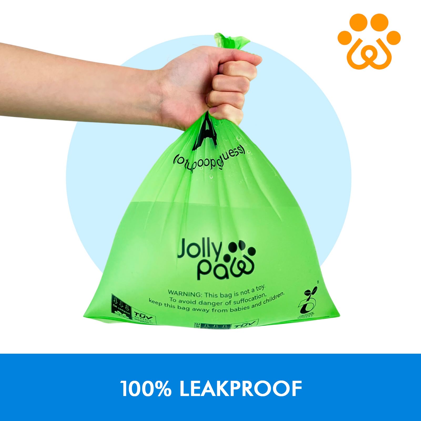 A hand holding a green, leakproof Jolly Paw bag with a warning label, against a light blue background.