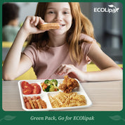 A well-balanced meal in a eco-friendly tray featuring tomatoes, broccoli, chicken, sausages, and pasta, set on a wooden table.
